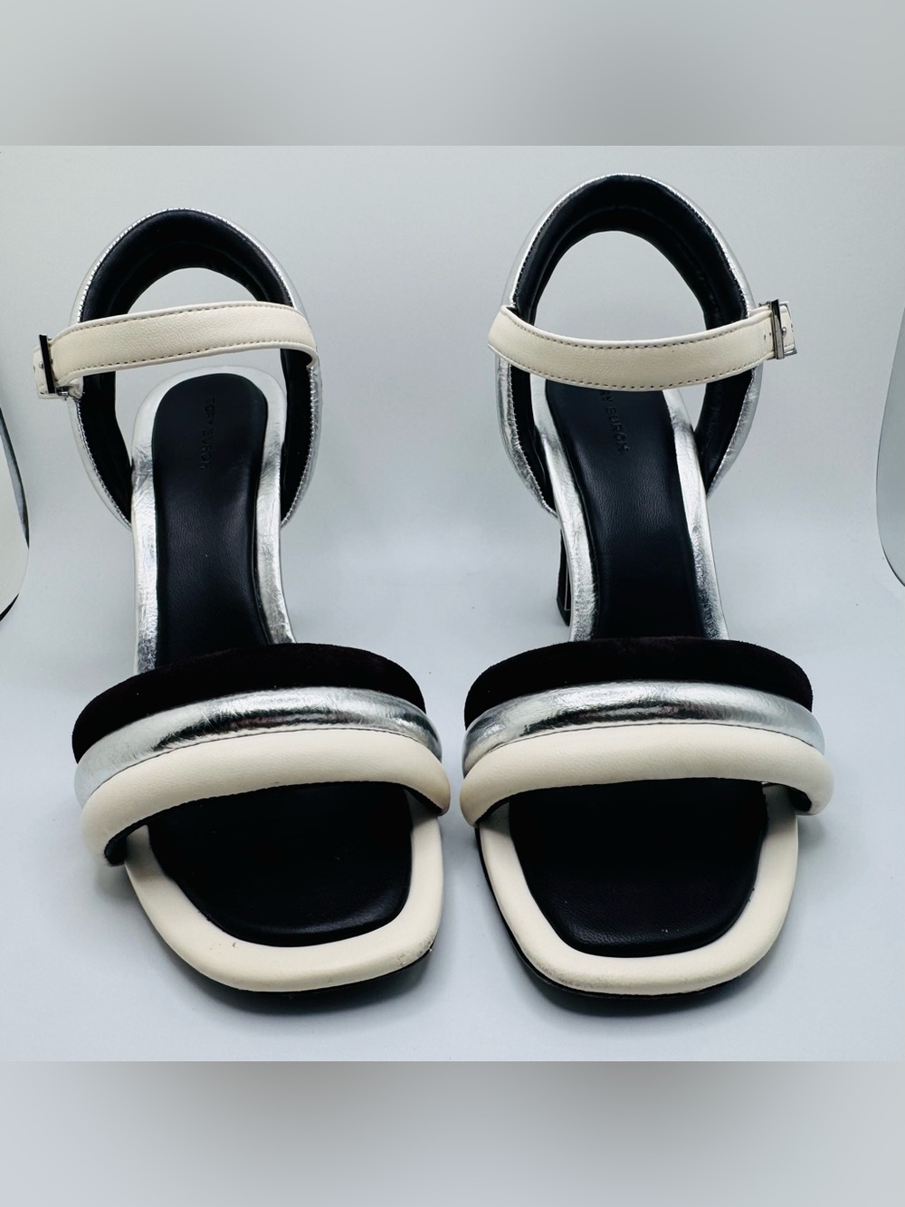 Tory Burch white/cream, black, and metallic-silver heeled sandal.